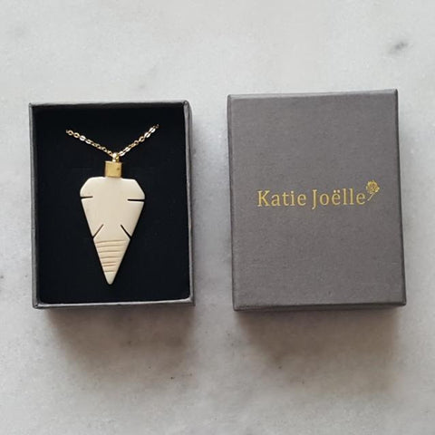 Image of Arrowhead Bone Pendant on a Long Gold Chain